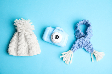 Photo of Flat lay composition with toy camera on light blue background. Future photographer