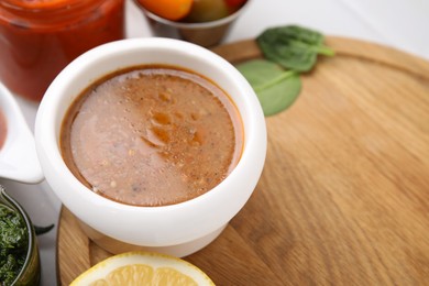 Photo of Fresh homemade marinade in bowl on table, closeup