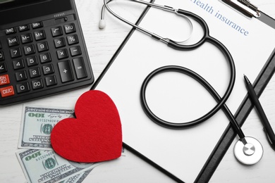 Photo of Flat lay composition with health insurance form, red heart and stethoscope on white wooden background