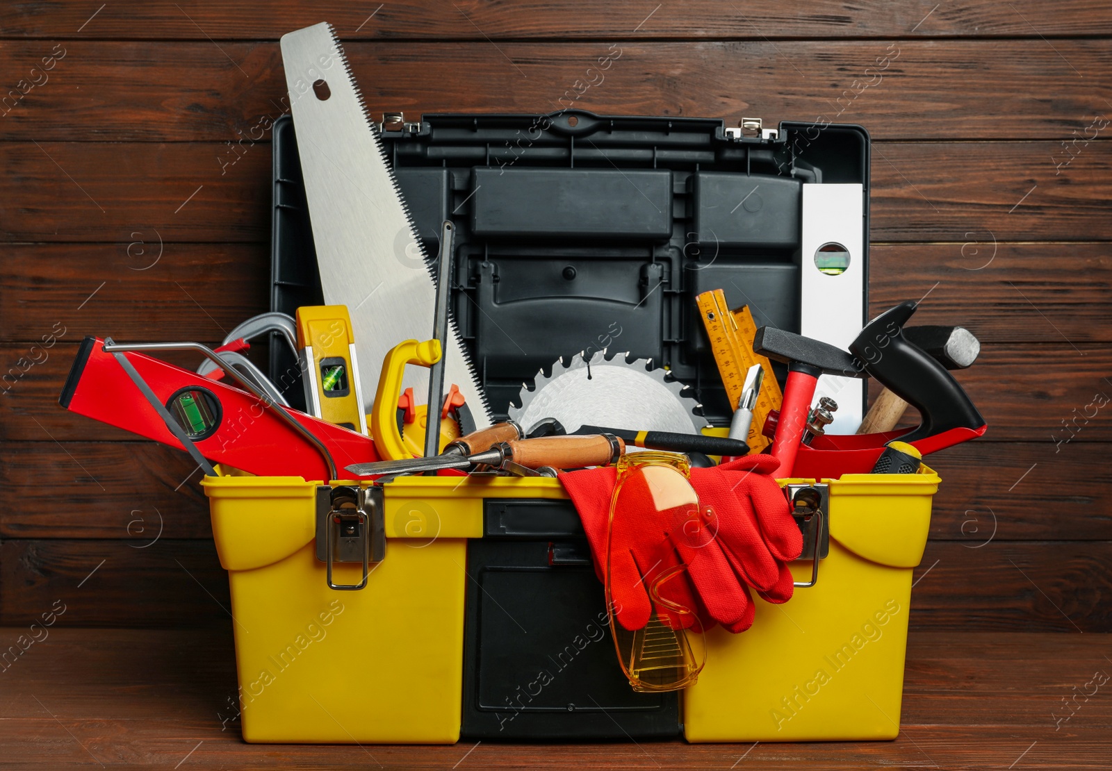 Photo of Box with different carpenter's tools on wooden table