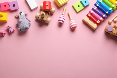 Photo of Flat lay composition with different toys on pink background. Space for text