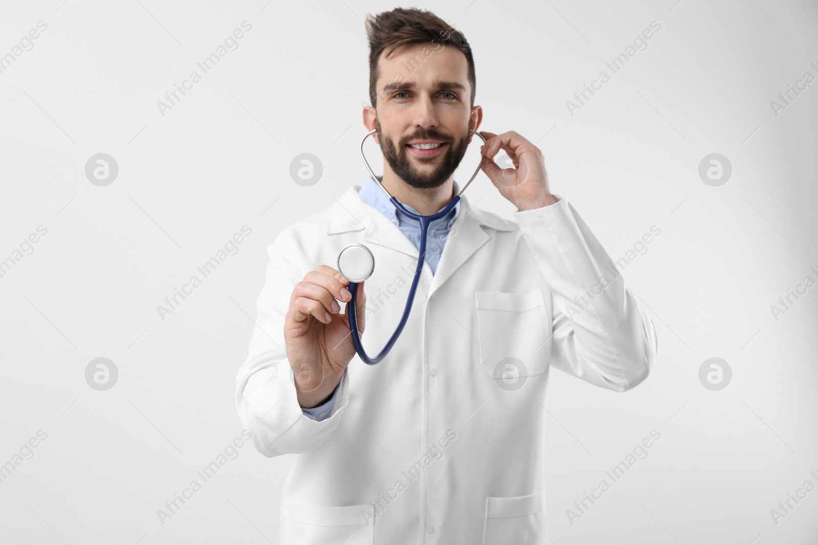 Photo of Doctor with stethoscope on white background. Cardiology concept