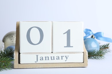 Photo of Block calendar and Christmas decor on white background. New Year celebration