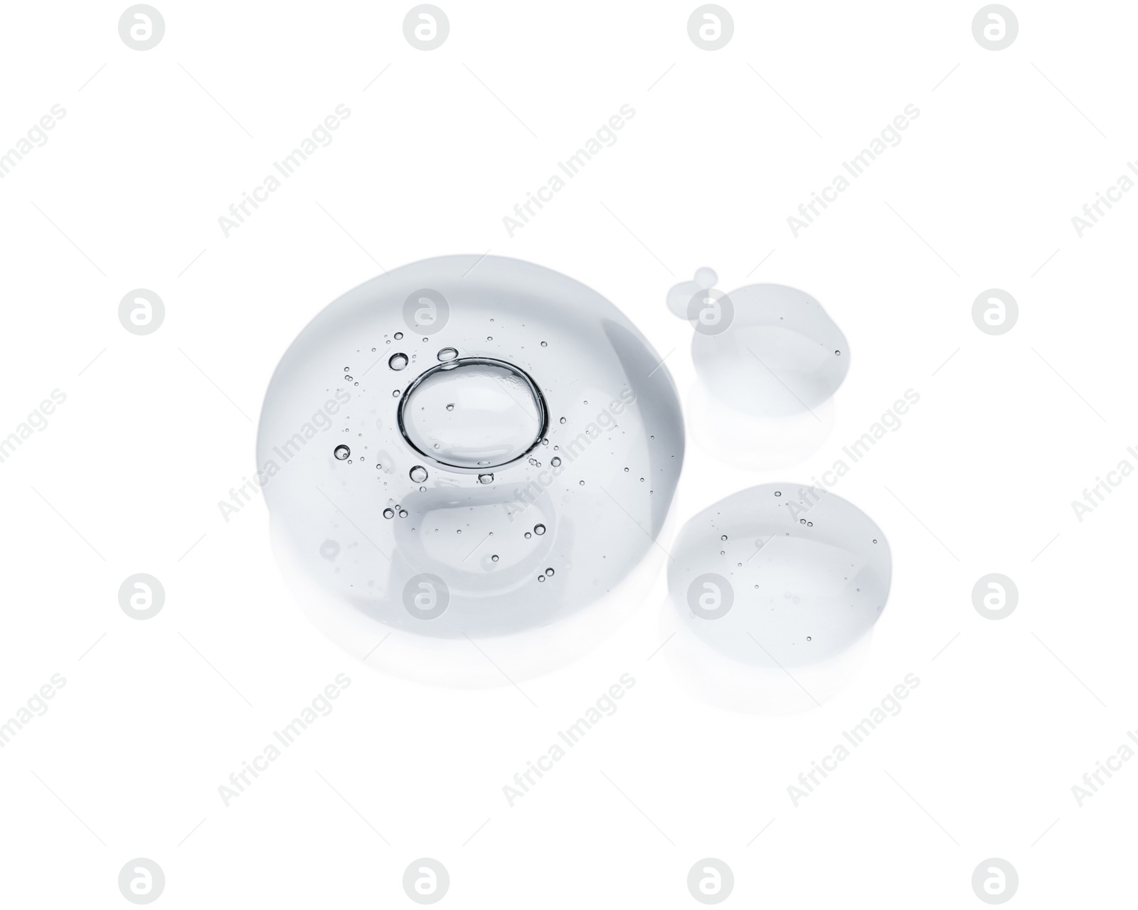 Photo of Drops of cosmetic oil on reflective surface, above view