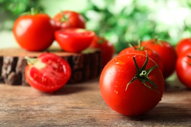 Photo of Fresh ripe tomatoes on wooden table, closeup