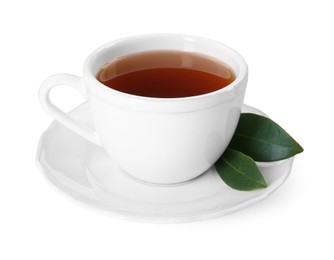 Aromatic tea in cup and green leaves isolated on white