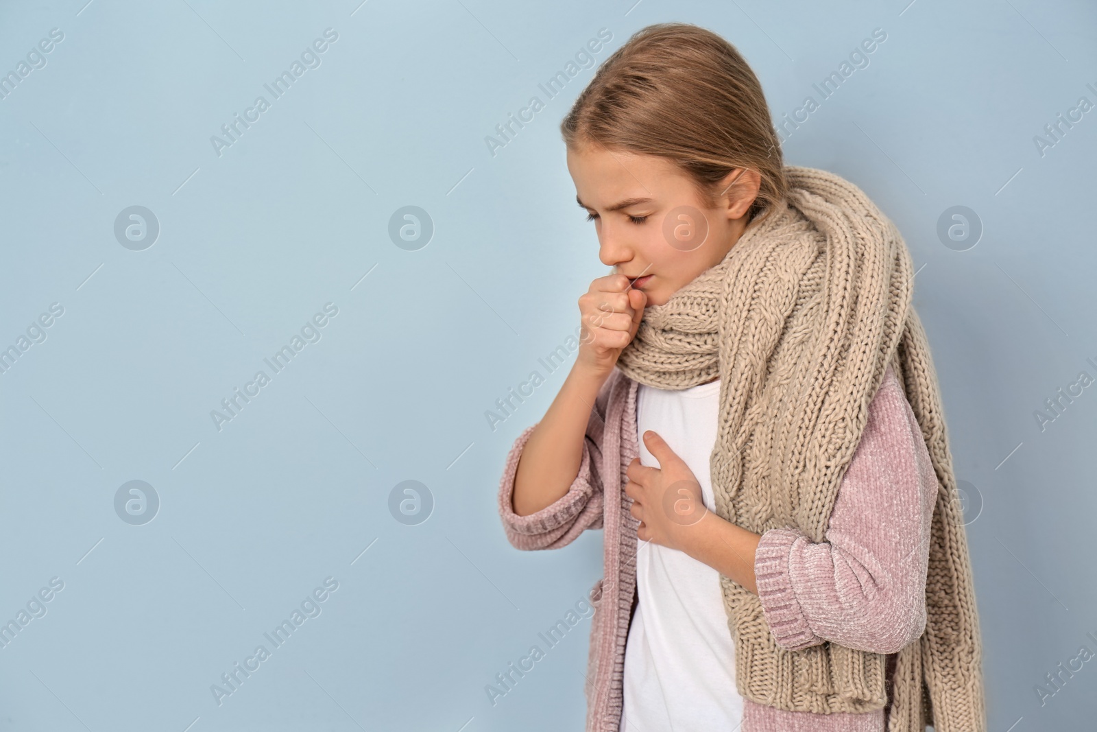 Photo of Girl coughing on light background