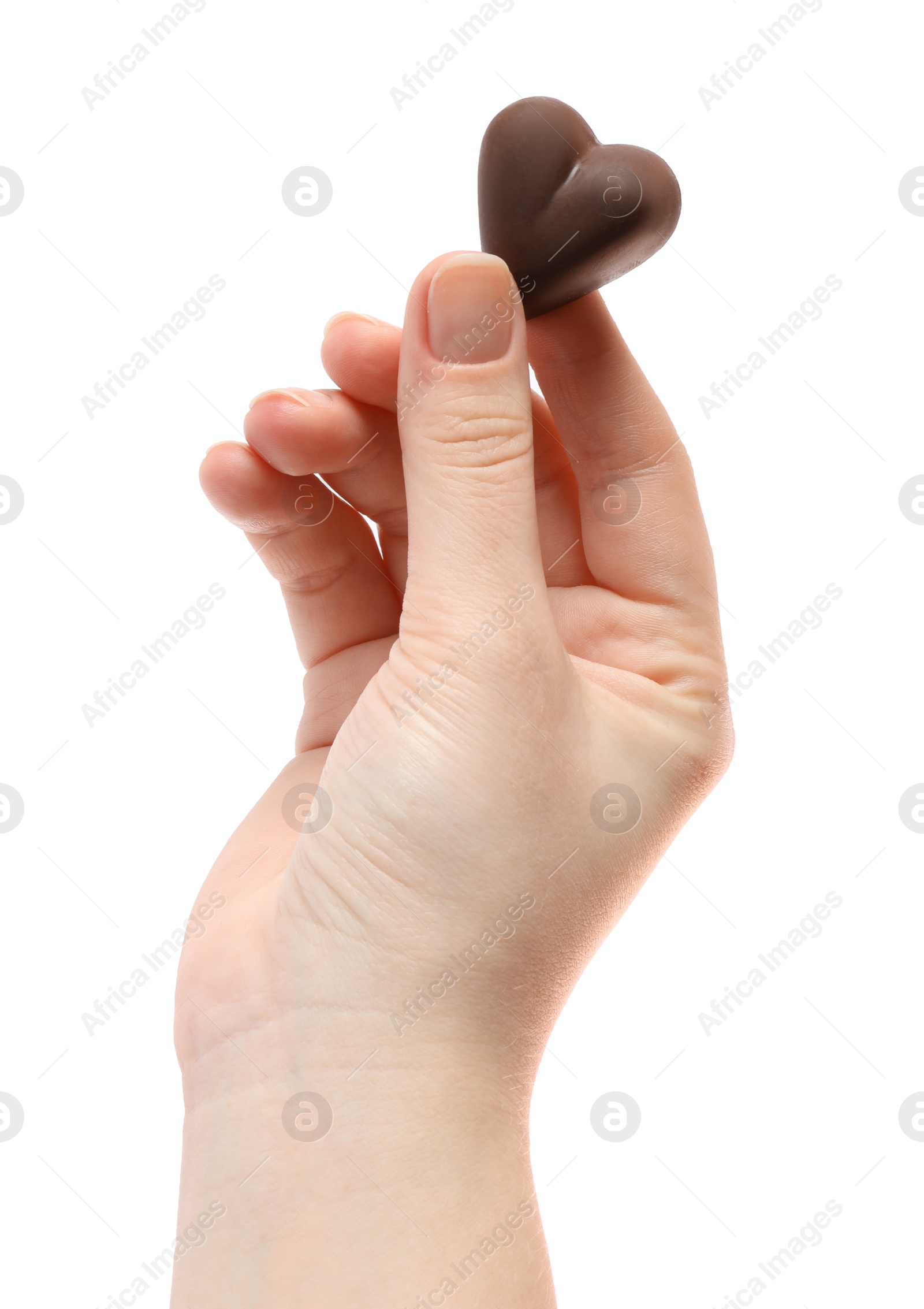 Photo of Woman holding heart shaped chocolate candy on white background, closeup