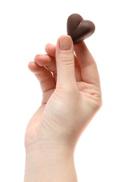 Woman holding heart shaped chocolate candy on white background, closeup