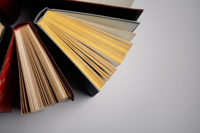 Hardcover books on grey background, flat lay