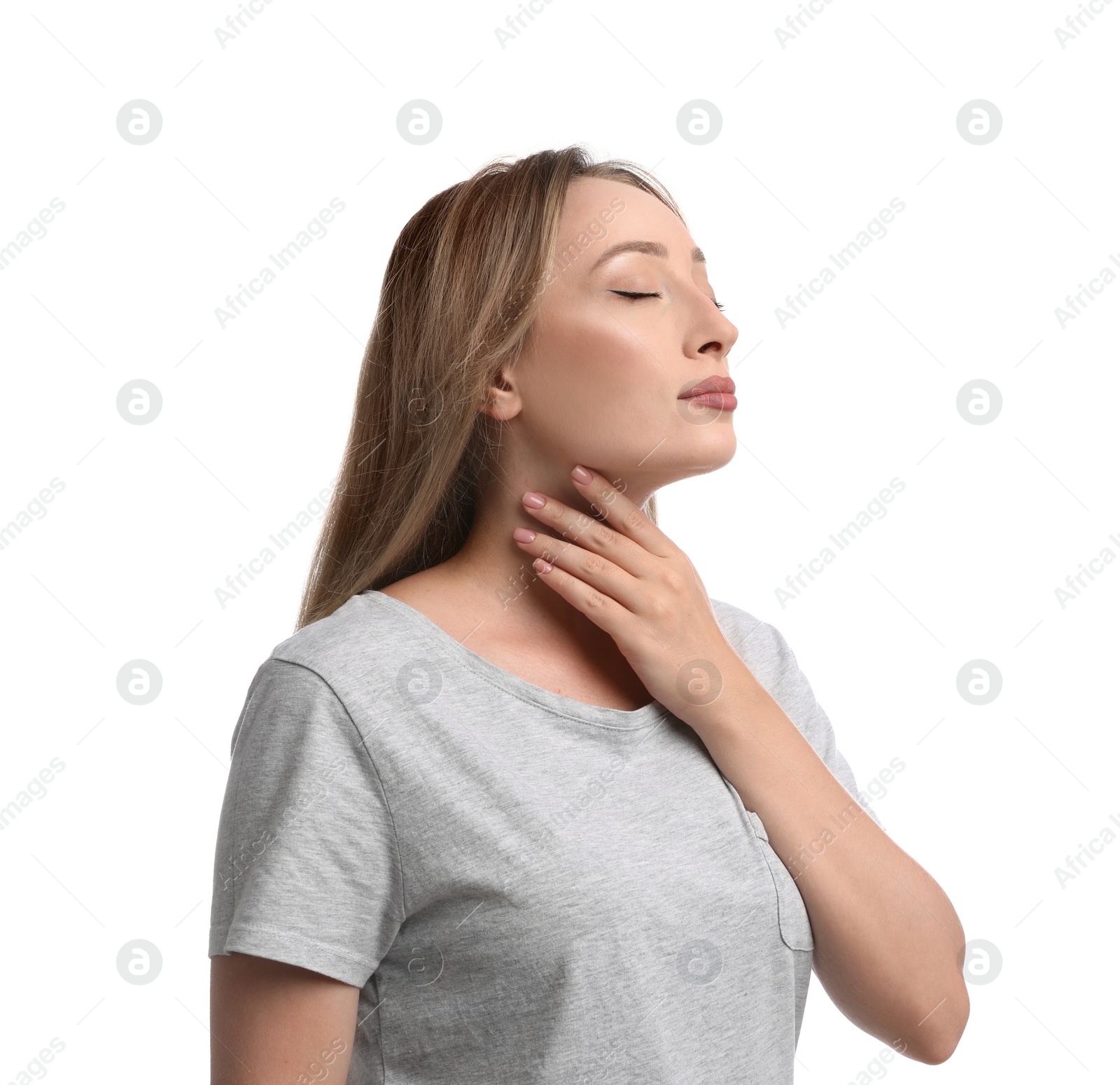 Photo of Young woman doing thyroid self examination on white background