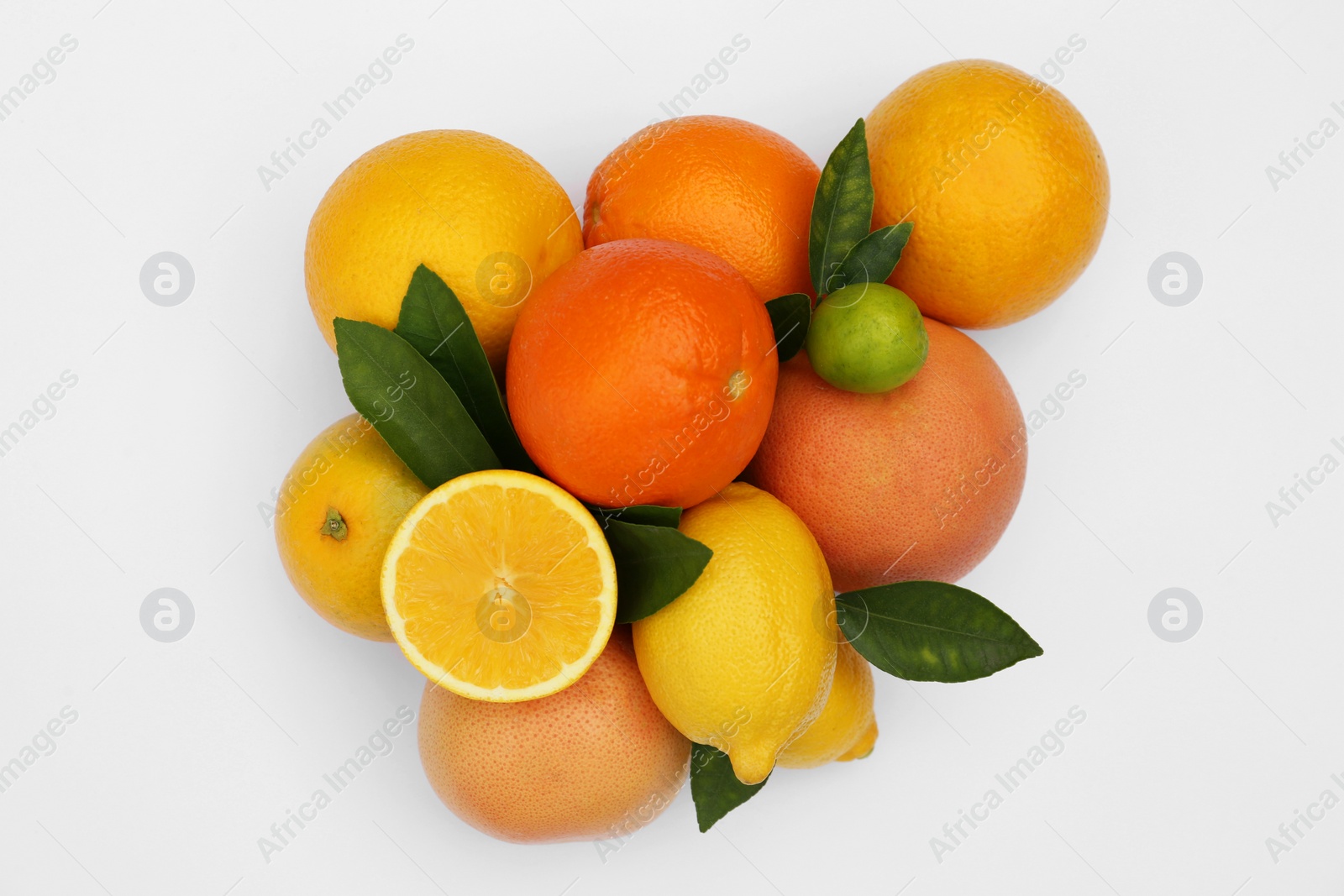 Photo of Different citrus fruits and leaves on white background, top view