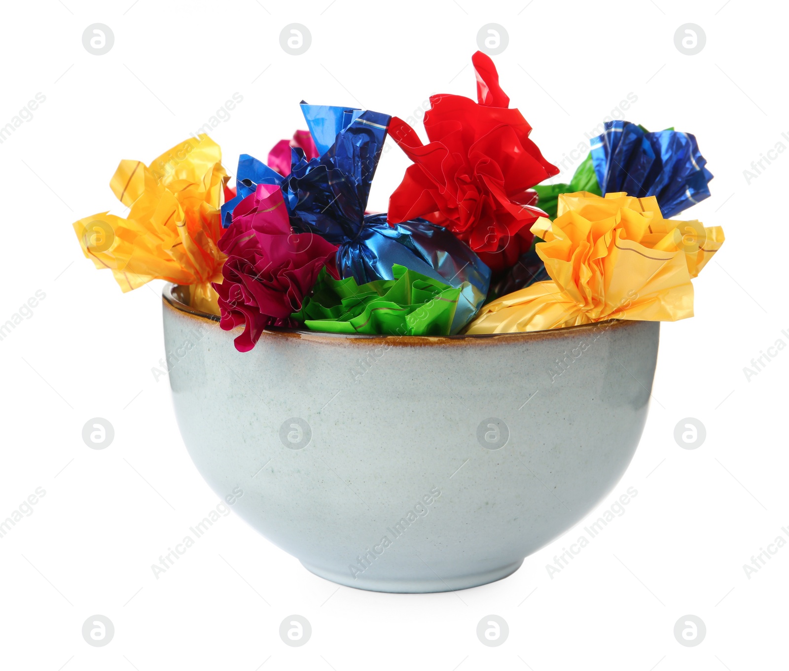 Photo of Bowl with candies in colorful wrappers isolated on white