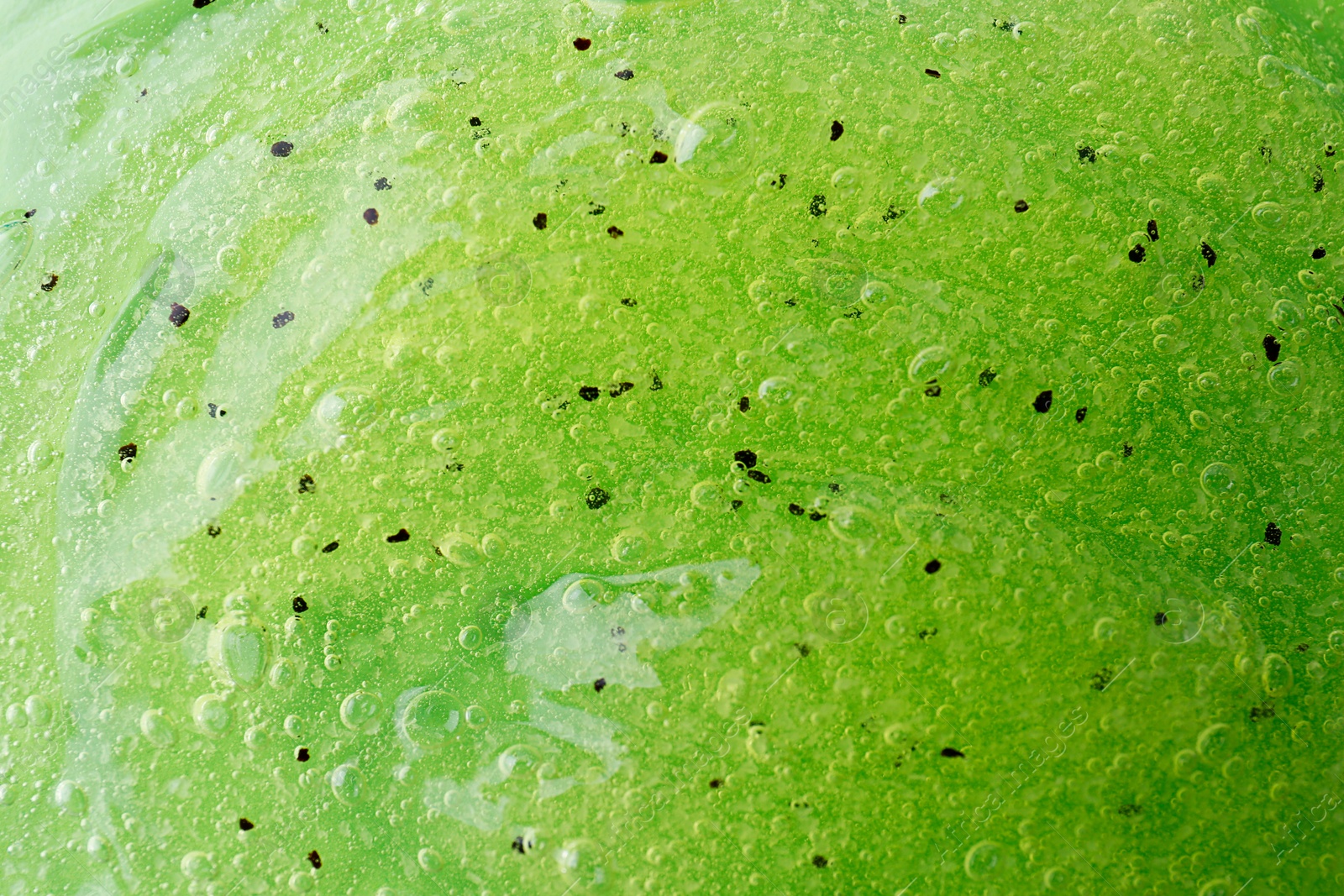 Photo of Texture of green shower gel as background, closeup