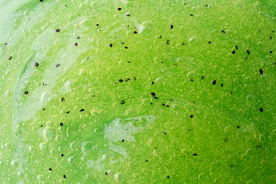 Photo of Texture of green shower gel as background, closeup