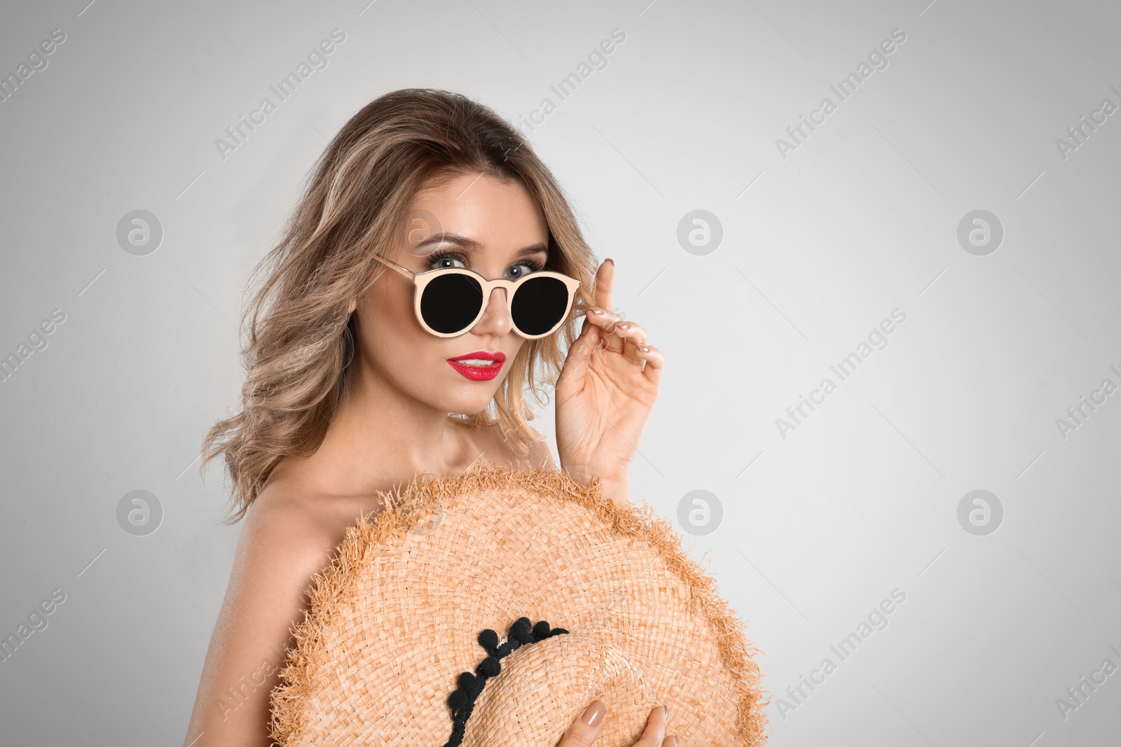 Photo of Young woman wearing stylish sunglasses on grey background. Space for text