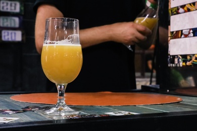 Photo of Glass of beer on bar counter in pub