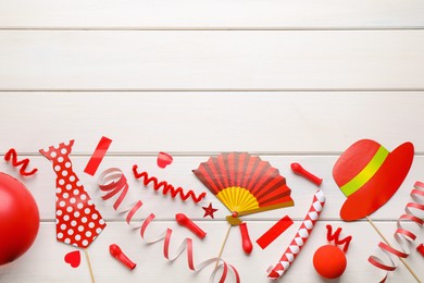 Photo of Flat lay composition with carnival items on white wooden background. Space for text