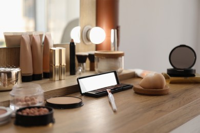 Photo of Many different cosmetic products on dressing table indoors