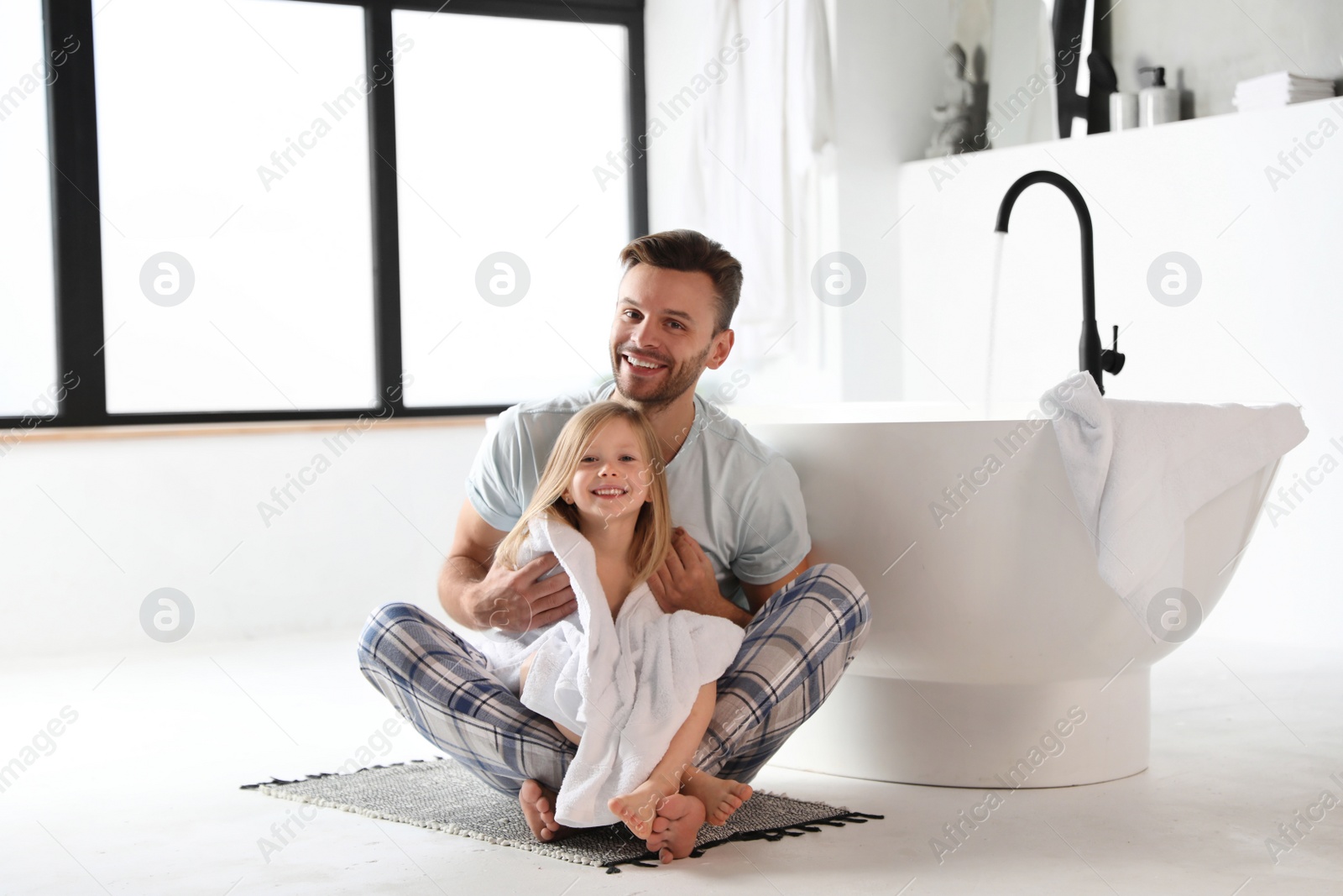 Photo of Father and his cute little daughter in bathroom