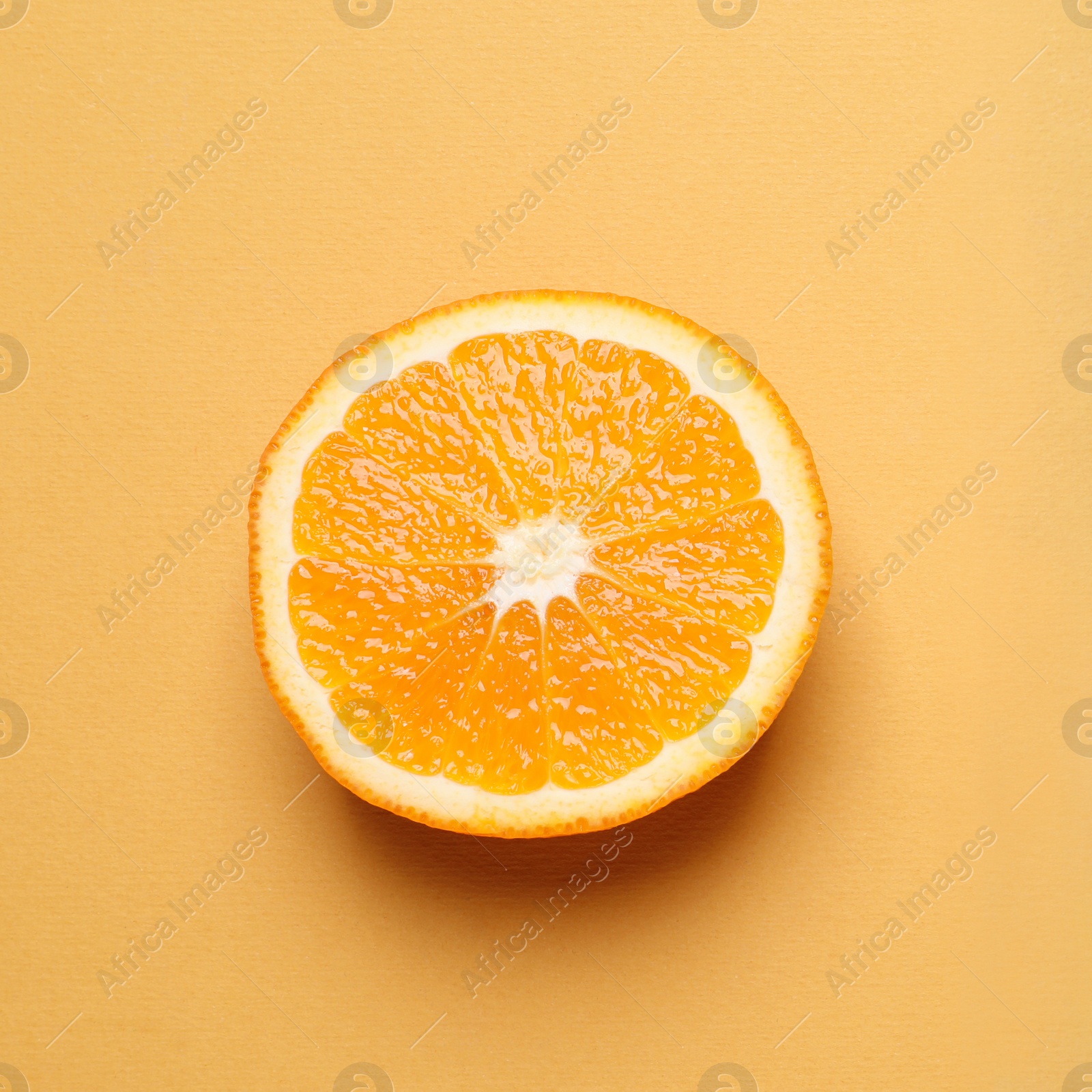 Photo of Cut orange on color background, top view