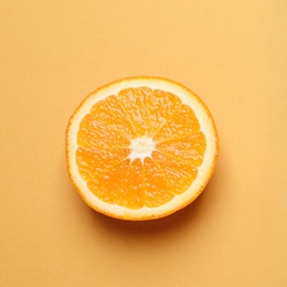 Photo of Cut orange on color background, top view