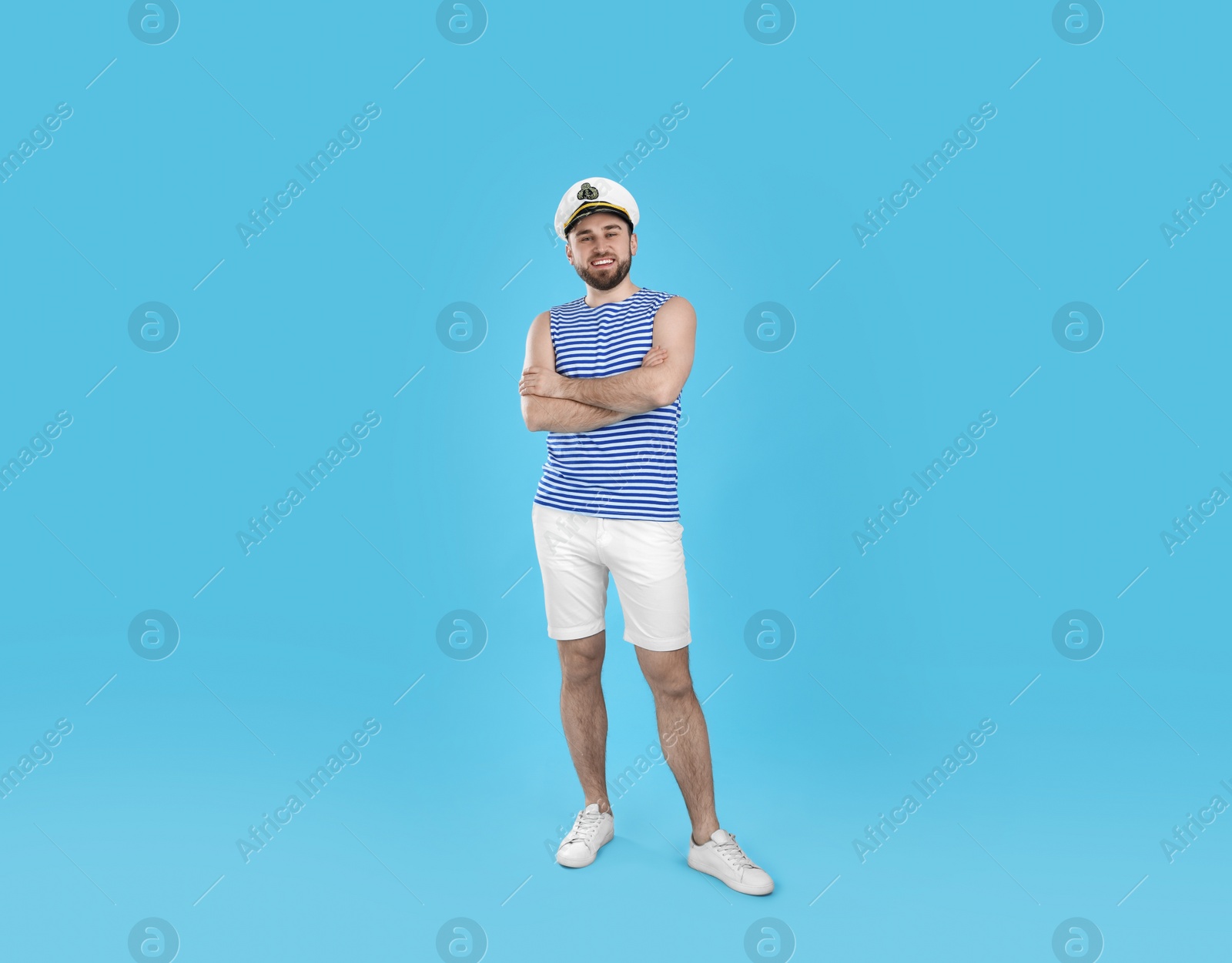 Photo of Full length portrait of sailor on light blue background