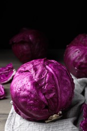 Wet red cabbage with water drops on wooden table