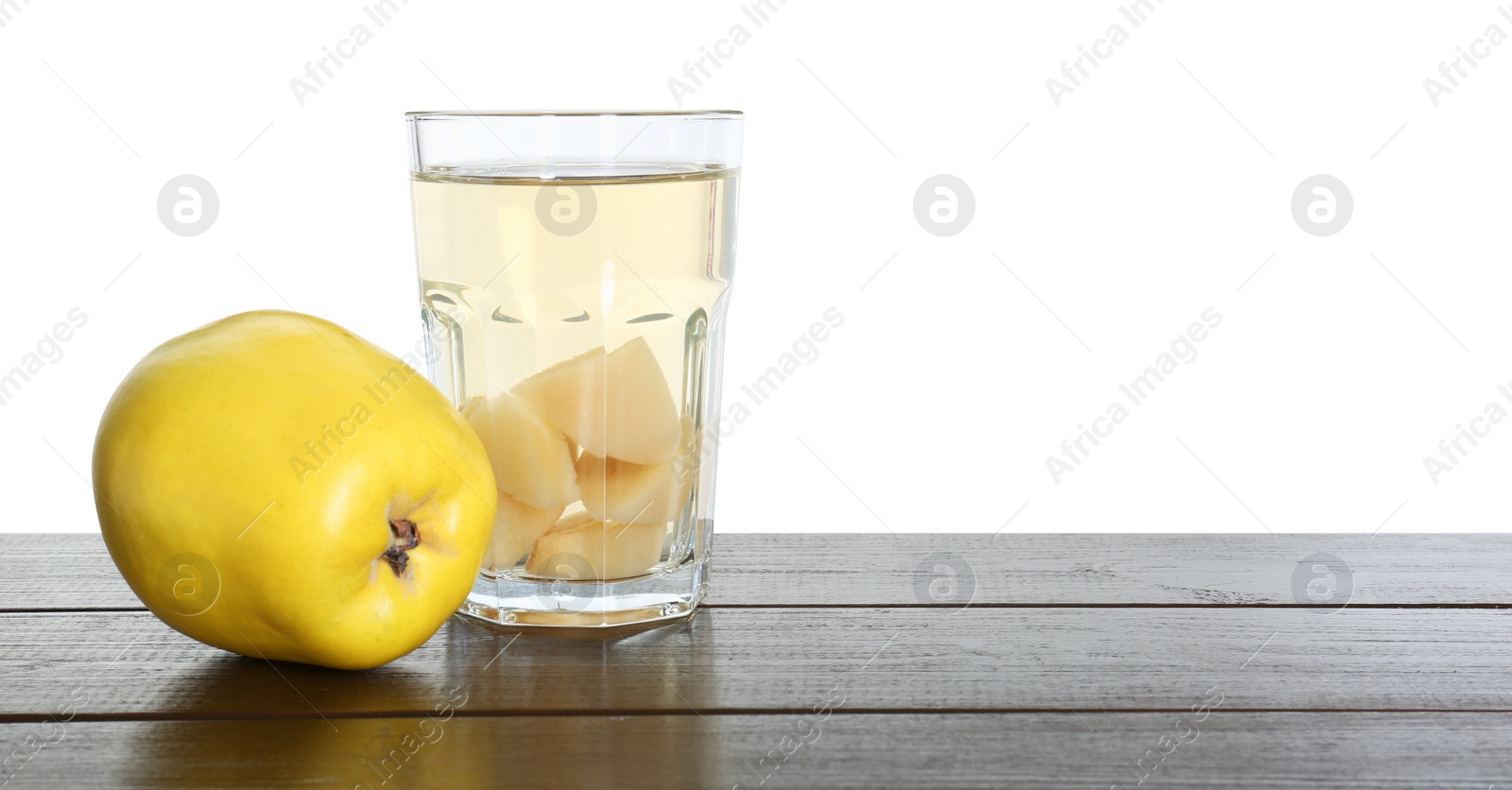 Photo of Delicious quince drink and fresh fruit on wooden table against white background