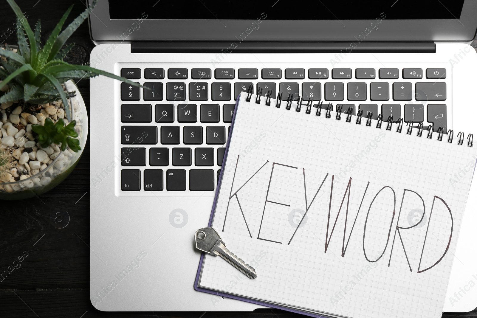 Photo of Composition with key, notebook and laptop on table, flat lay. Keyword concept