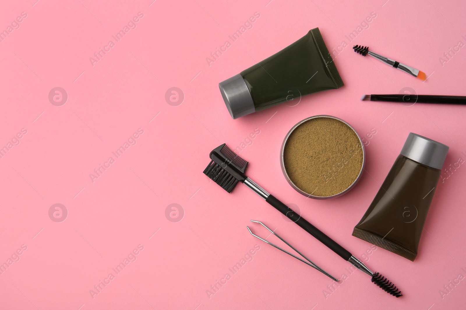 Photo of Flat lay composition with eyebrow henna and tools on pink background. Space for text