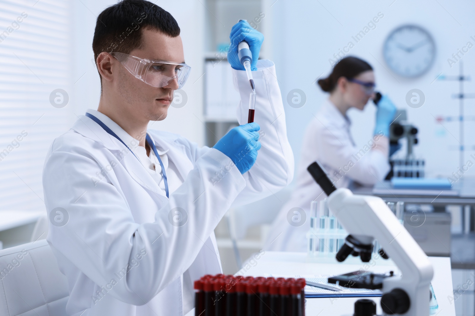 Photo of Scientist dripping sample into test tube in laboratory