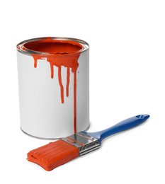 Photo of Can of orange paint and brush on white background