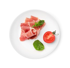Photo of Plate with rolled slices of delicious jamon, cut tomato and basil isolated on white, top view