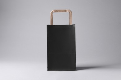 Black paper bag on light grey background