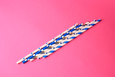 Photo of Paper drinking straws on pink background, flat lay