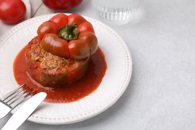 Photo of Delicious stuffed bell pepper served on light table. Space for text