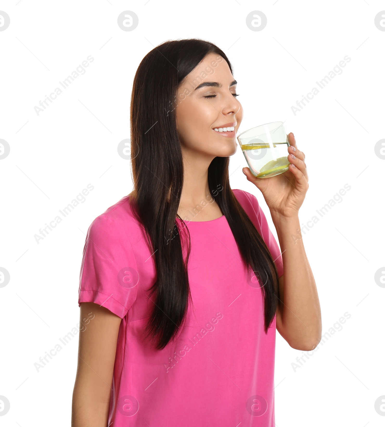 Photo of Beautiful young woman drinking tasty lemon water on white background