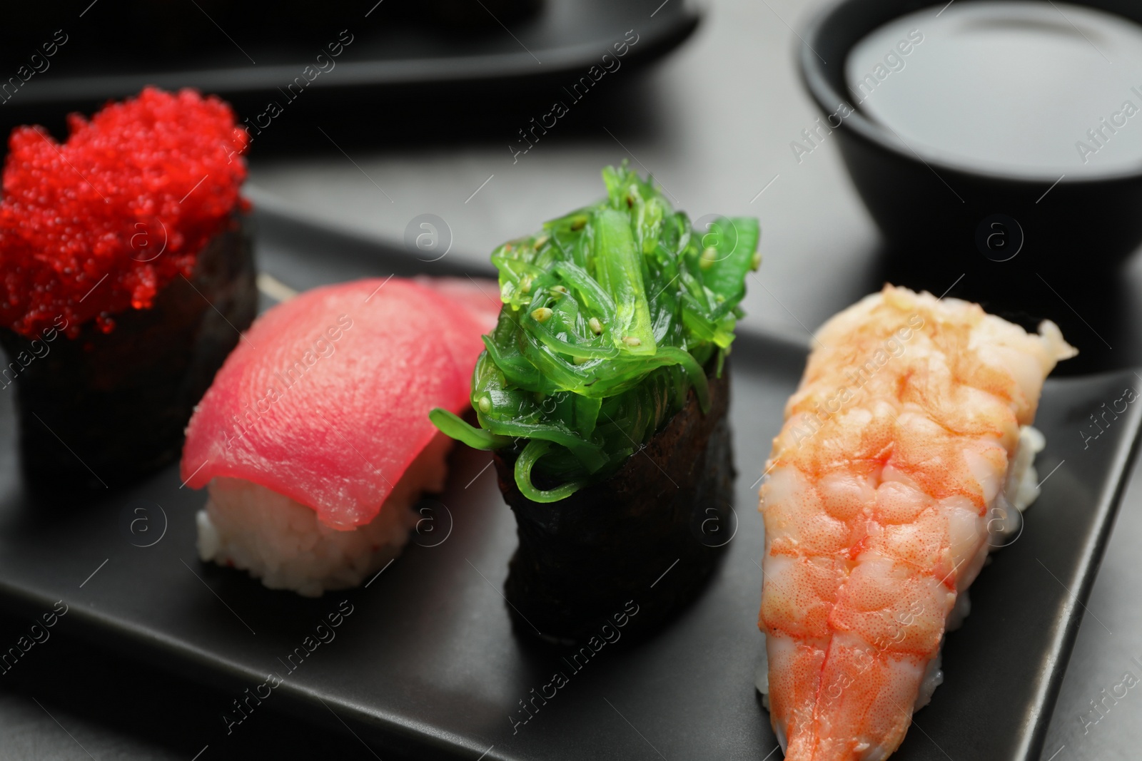 Photo of Set of delicious sushi on plate, closeup