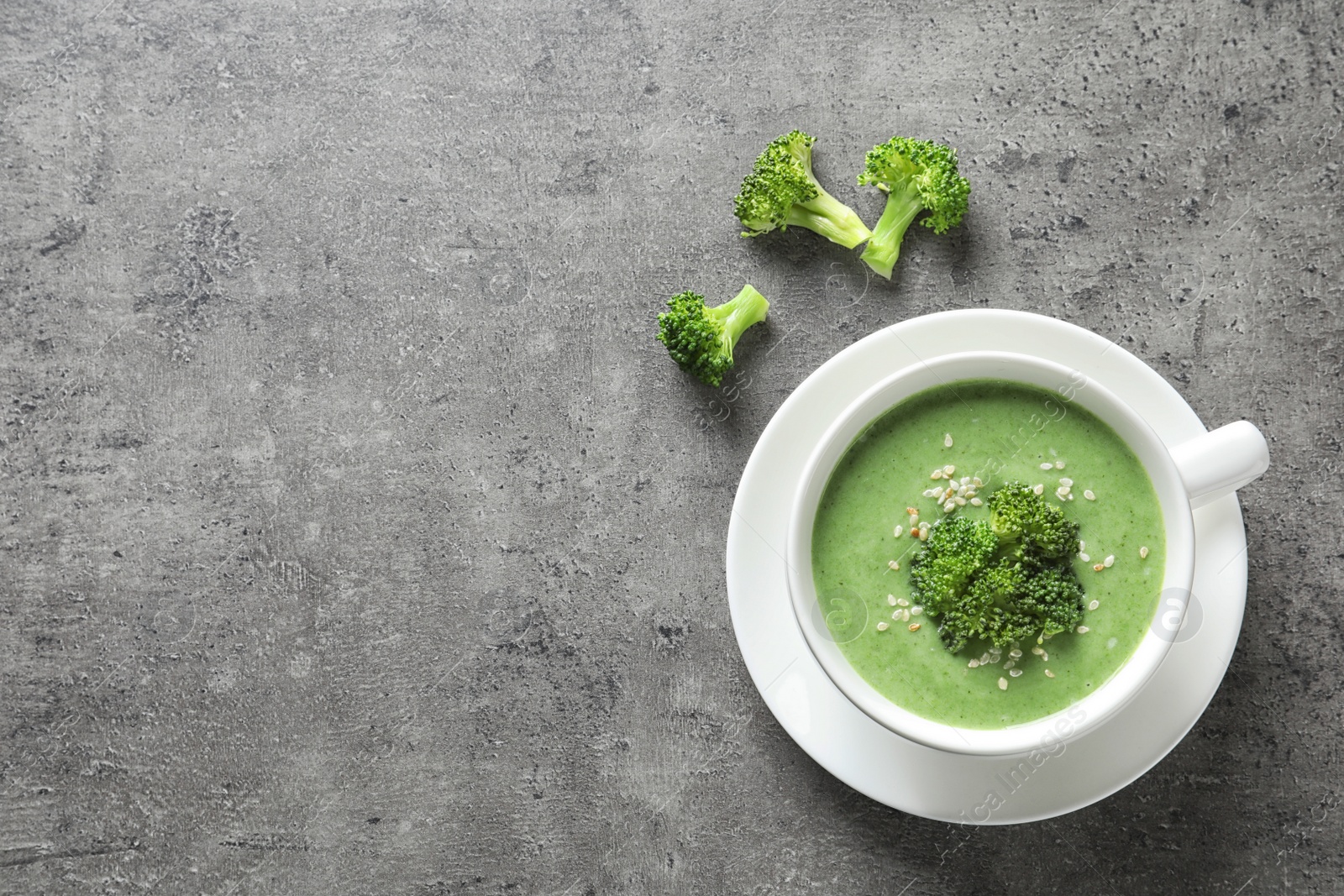 Photo of Fresh vegetable detox soup made of broccoli in dish and space for text on table, top view