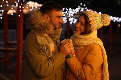 Happy couple spending time at Christmas fair