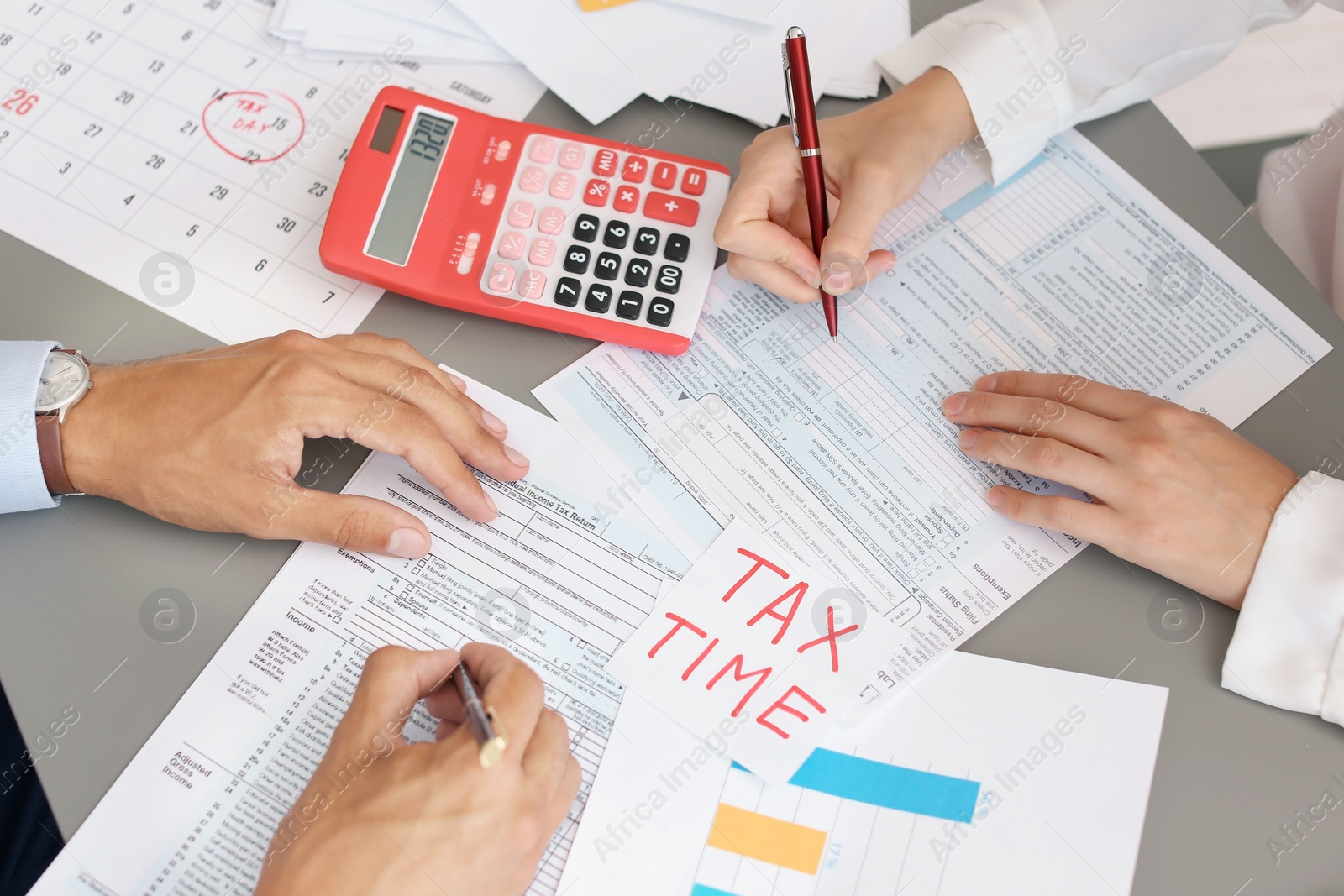 Photo of Tax accountants working with documents at table