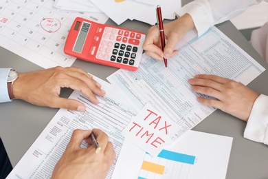 Tax accountants working with documents at table