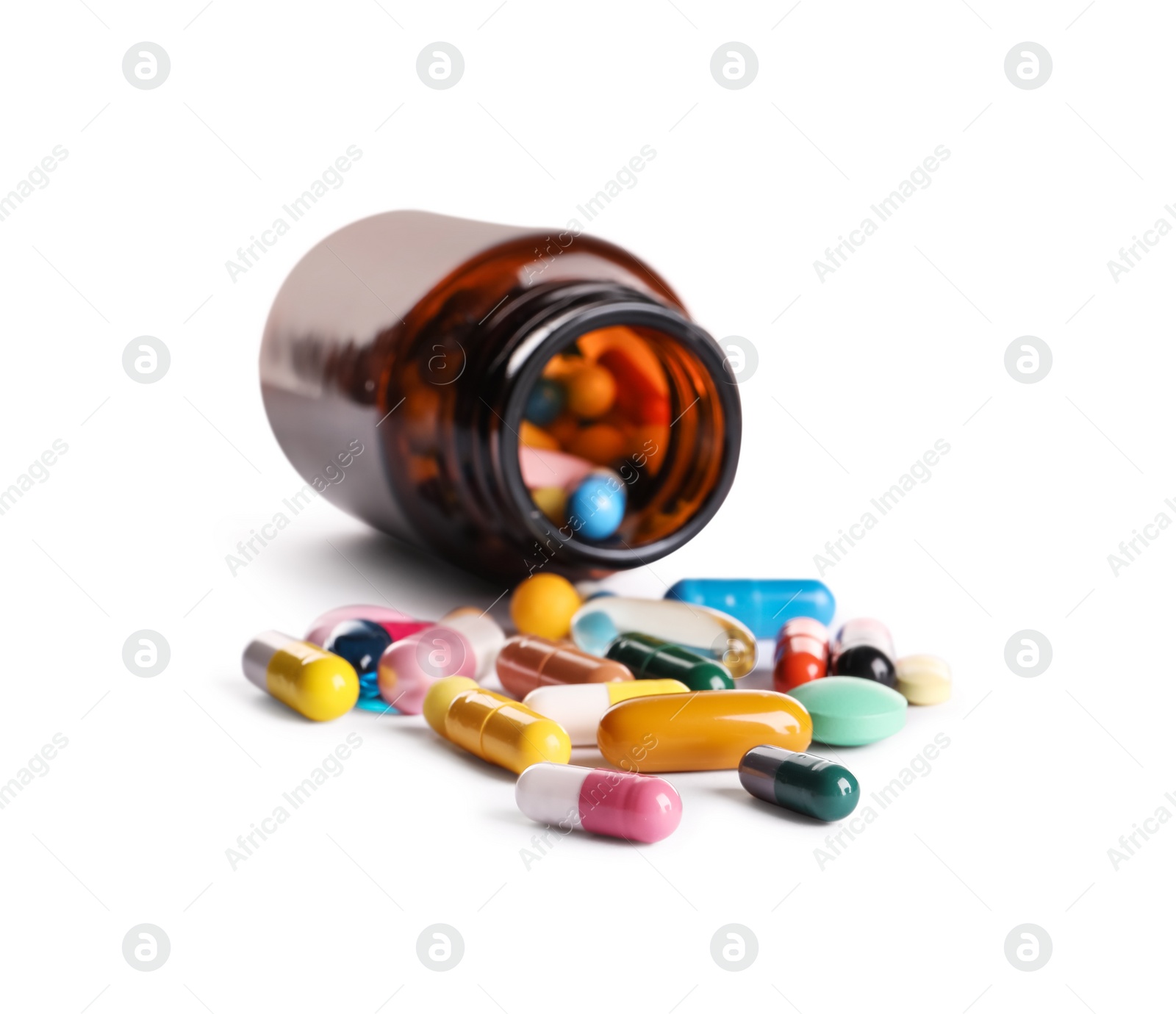 Photo of Plastic medical bottle with many different pills isolated on white