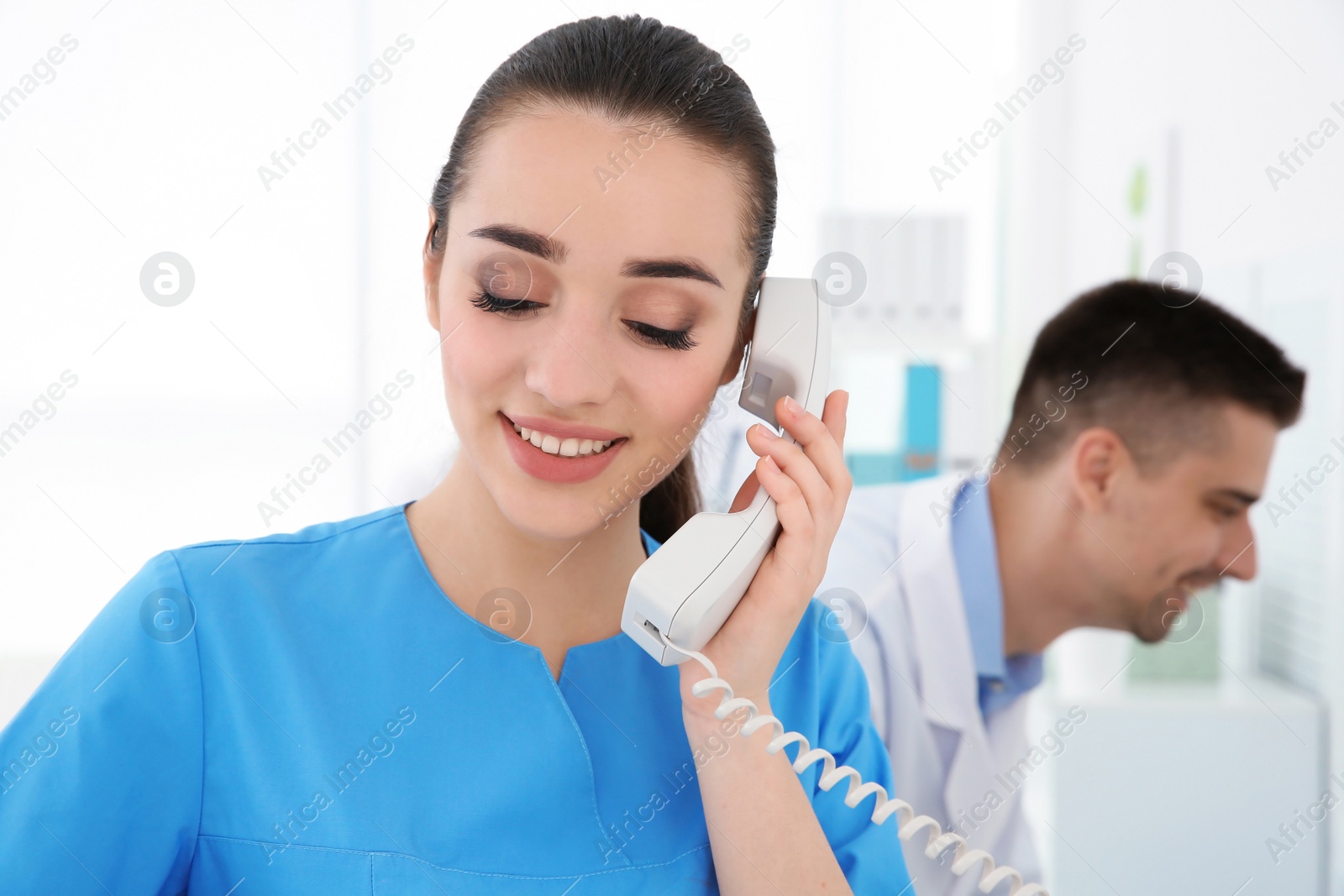 Photo of Young female receptionist working in hospital