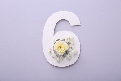 Paper number 6 and beautiful flowers on light grey background, top view