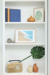 Photo of Books and different decorative elements on shelving unit