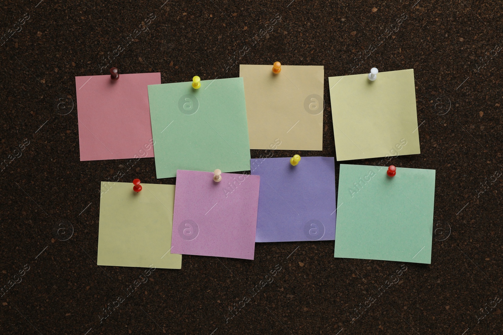 Photo of Colorful paper notes pinned to cork board