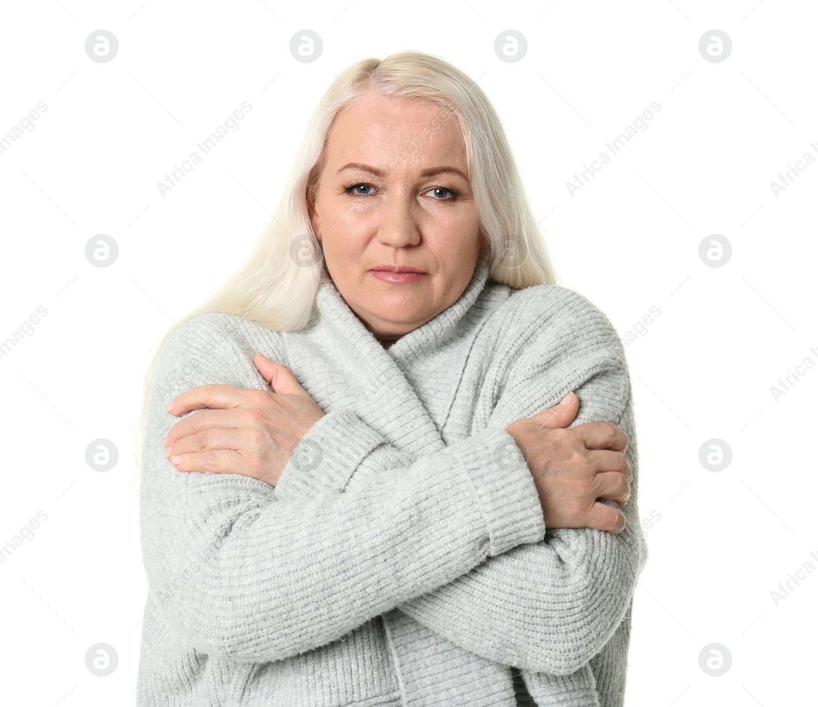 Photo of Mature woman in warm clothes suffering from cold on white background