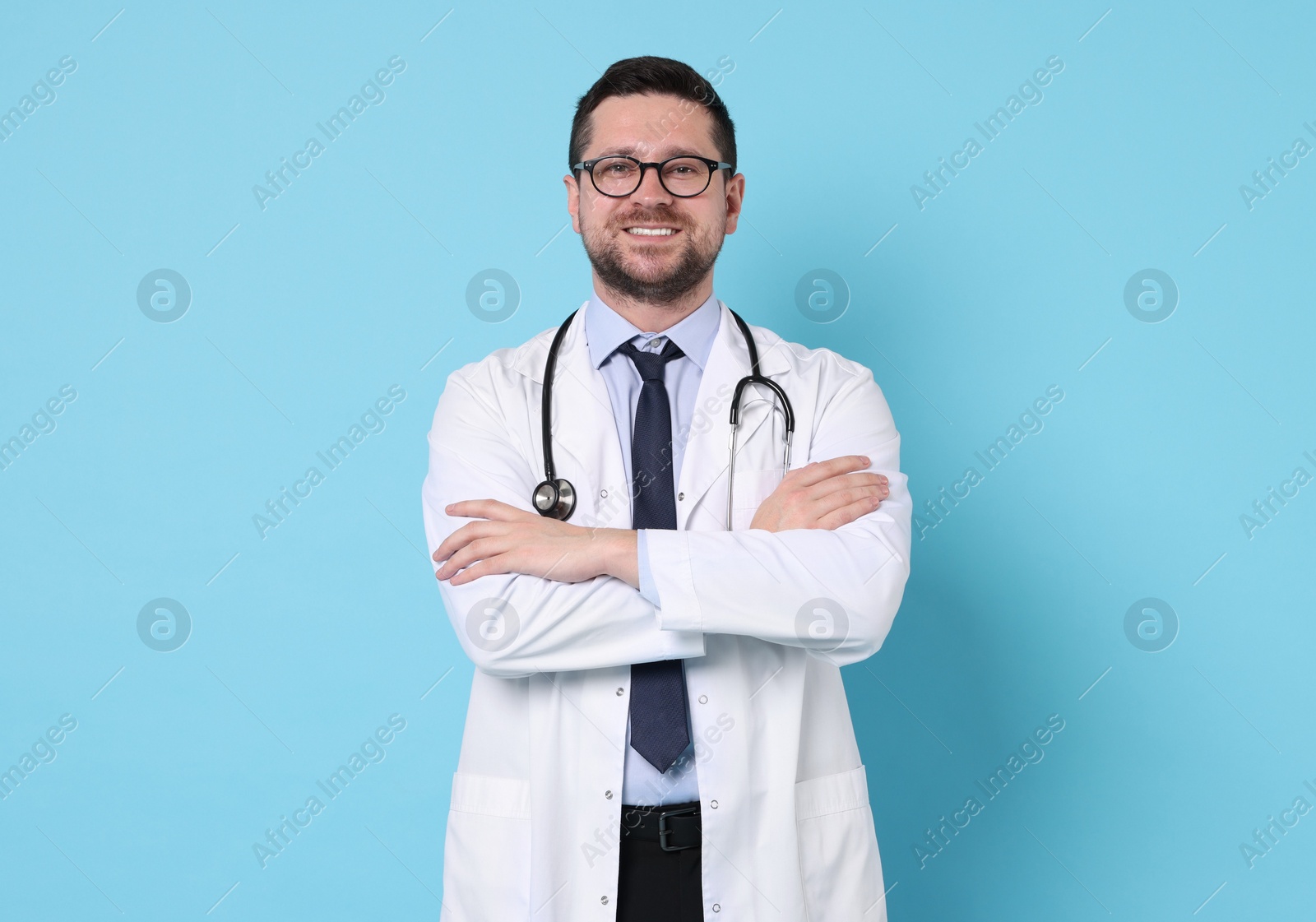 Photo of Portrait of smiling doctor on light blue background